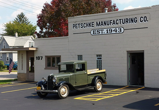Petschke Manufacturing antique truck in front of building